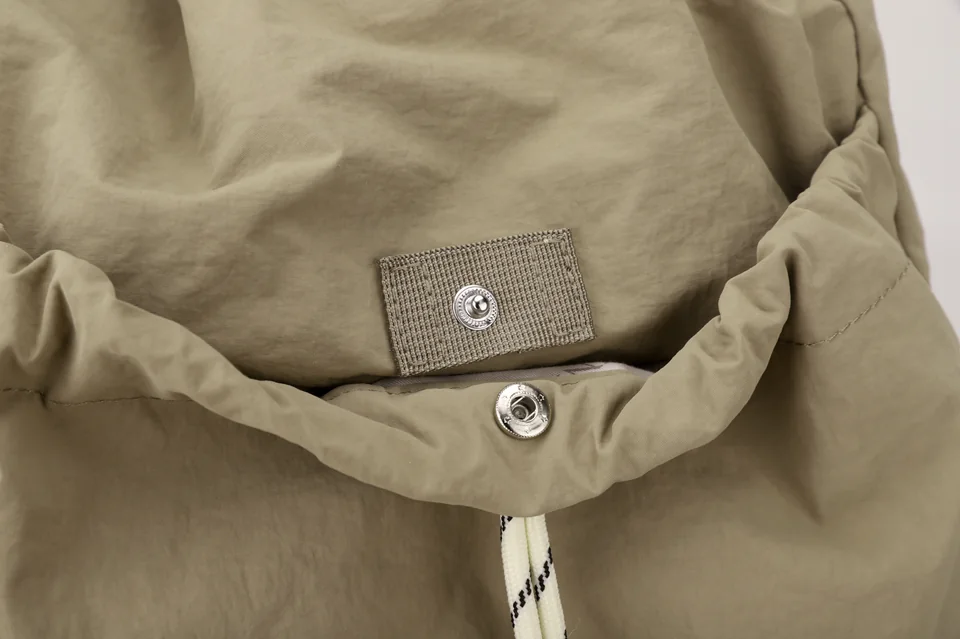 Close-up of a magnetic snap closure and reinforced webbing patch.