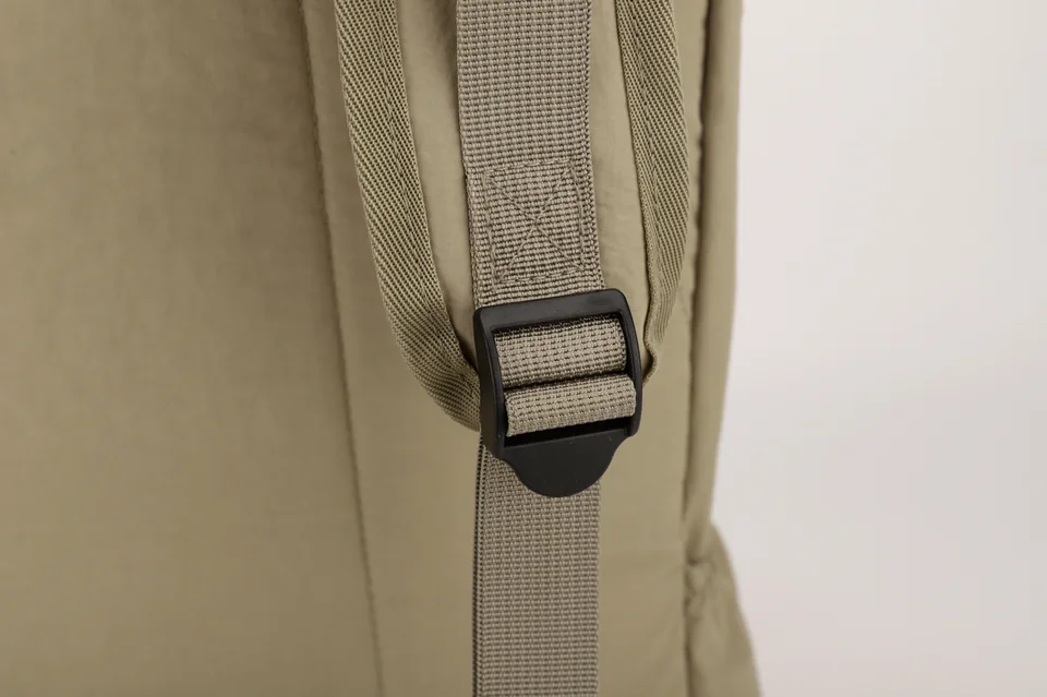 Close-up of a shoulder strap adjuster and webbing.