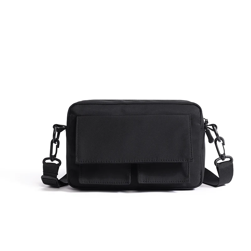 Black crossbody bag on a plain background.