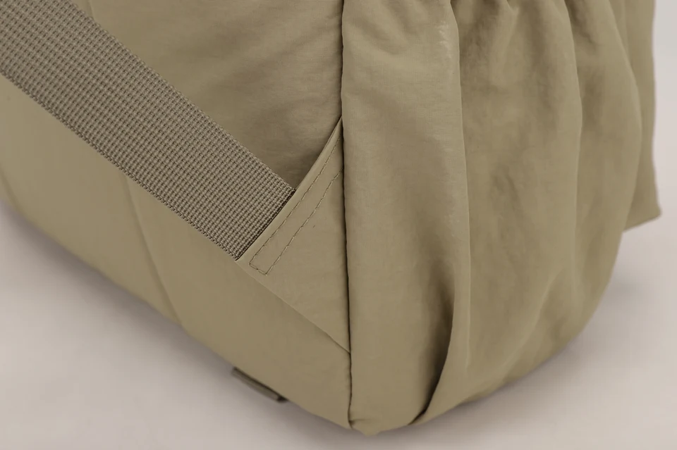 Close-up of stitching at a bag strap attachment.
